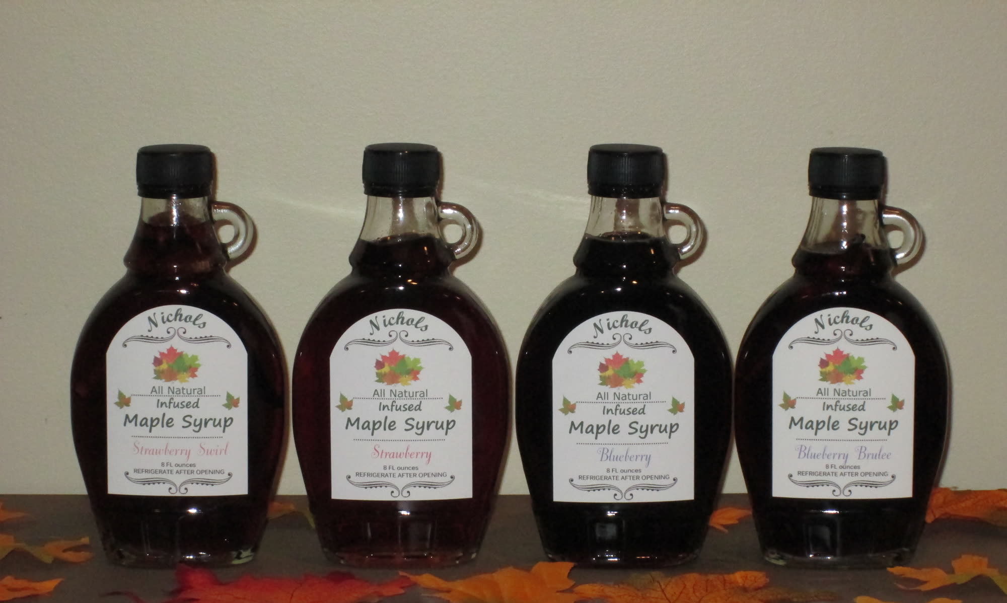 Four bottles of Nichols berry-infused maple syrup
