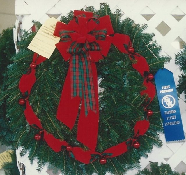 A decorated Nichols wreath with a red bow and a First Premium ribbon from the Eastern States Exposition